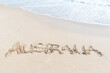 © Neal Pritchard/Stocksy - The word Australia written in the white beach sand