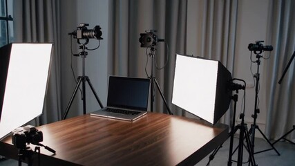 Poster - Professional office setup with laptop, camera, softbox light, tripod, and wooden table for video production or online meeting