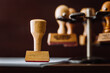 © J.Rynio PHOTOGRAPHY/Stocksy - Wooden Rubber stamp on office desk.