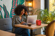 © Aleksandra Jankovic/Stocksy - Professional Woman Working on Laptop in a Cozy Cafe Setting