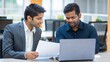 © N7 - Indian Business Colleagues Discussing Ideas in Open Office Space