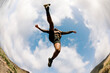 © Adrian Rodd/Stocksy - Wide, low angle shot of a trail runner taking a long stride