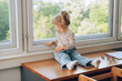 © AUDSHULE/Stocksy - Toddler perched on countertop