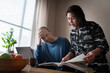 © Johnér - Mature woman reading book with stressed man at home