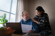 © Johnér - Happy woman with man working on laptop at home
