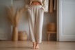 © SERHII - Cozy minimalist beige loungewear outfit in modern living room