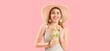© Pixel-Shot - Beautiful happy woman in swimsuit holding tasty mojito on pink background