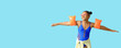 © Pixel-Shot - Happy African-American girl in swimsuit with inflatable armbands on blue background