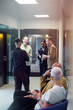 © Johnér - Team of business professionals talking with each other in office corridor