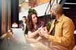 © Johnér - Male and female corporate professionals planning strategies with each other in office