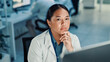 © peopleimages.com - Computer, science and thinking with woman in laboratory for online development or research. Healthcare, innovation and problem solving with Asian scientist at desk for breakthrough or clinical trial