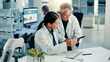© peopleimages.com - Science, team and discussion on tablet in lab for medical research, vaccine report and experiment. Scientist, people and digital app for pharmaceutical development, biotechnology study and innovation