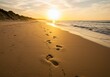 © 5 Grace Media - Footprints in the sand lead along a quiet beach at sunset, with waves gently touching the shore
