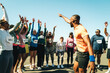 © Jacob Lund - Group of runners cheering and celebrating at a community event
