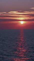 Wall Mural - soft golden sunlight descending over tranquil ocean waters, generating mesmerizing reflective patter