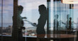 © peopleimages.com - Discussion, window reflection and business women in office with partnership for finance report. Meeting, collaboration and female financial advisors for company budget planning in workplace.