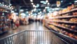 © hestywinarni - Shopping cart in grocery store aisle view