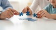 © Meow Creations - Family hands assembling a blue puzzle, symbolizing teamwork and problem solving