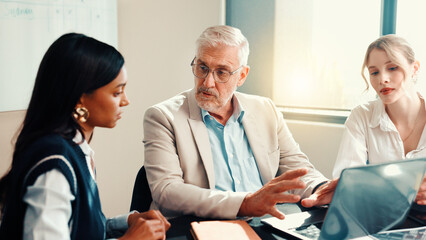 Poster - Talking, mentor or business people on laptop with feedback for teamwork, collaboration and investment. Investor, mature or manager in office with technology for project, budget and risk management