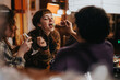 © qunica.com - A group of friends gathered for dinner, sharing food and drinks in a cozy setting. The image showcases friendship, laughter, and a warm social interaction around a dining table.
