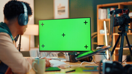 Poster - Green screen, computer and man with live streaming in home for editing project on videography. Technology, content creation and back of male influencer with recording for online podcast in apartment.