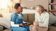 © Claytonon/peopleimages.com - Tablet, sad and nurse with senior woman on sofa for medical service, consulting or support. Nursing home, healthcare and caregiver with empathy for patient on tech for results, diagnosis or bad news
