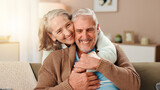 Senior woman, man and hug on sofa with smile, care and bonding with love in retirement in lounge. Elderly people, couple and embrace with trust, loyalty and happy marriage in living room at house