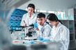 © Irin - Group of young scientists in lab coats collaborate in a high-tech laboratory, analyzing samples through a microscope and documenting results, symbolizing innovation, teamwork, and modern research.