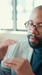 Poster - Business, call center and man in office, talking and help desk with communication. African person, employee and conversation in workplace, customer service and support with advice and professional