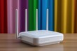 © Tahmina - White wireless router on wooden table with rainbow background