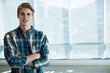 © WavebreakMediaMicro - Man in his thirties wearing shirt standing inside office by floor-to-ceiling windows, copy space