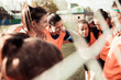 © Davor - Female soccer team in huddle before game on outdoor field