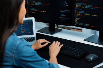 young asian in it developer creating with typing online information on pc with coding program data o