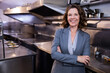© WavebreakMediaMicro - Senior woman supervising salad plating in restaurant kitchen with steel counters, copy space