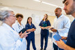 © unai - Medical team meeting discussing patient charts in hospital room