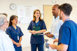 © unai - Medical team meeting discussing patient charts in hospital room