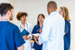 © unai - Medical team meeting discussing patient charts in hospital