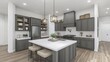 © ddwi - A modern farmhouse-style kitchen with a large island.