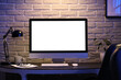 © Pixel-Shot - Blank computer monitor with glowing lamp on desk in dark office at night