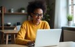 © liu - African american woman learning online with laptop. High quality
