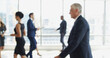 © peopleimages.com - Blur, busy and moving with business people in lobby of office for corporate productivity. Walking, window and work with professional employee group in convention center for development seminar