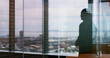 © peopleimages.com - Silhouette, business and person at window in office for architecture, career ambition and buildings. Architect, vision and property development, urban infrastructure and city view for town expansion
