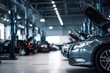 © ttonaorh - Car repair shop, a grey with an open hood in the foreground and other cars on lifting platforms for maintenance in the background. Car service center interior. Blurred background of a car workshop.
