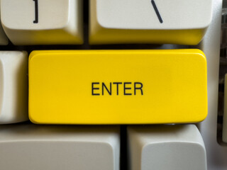 large yellow enter button on mechanical white keyboard for programmers with gray shades and red swit