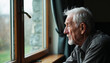 © Arra Vais - Elderly loneliness reflected in senior man looking out window. Elderly loneliness depicted in thoughtful senior gazing from window.  Lonely senior man sits by window, contemplating life.
