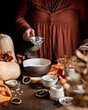 © ADDICTIVE STOCK - Autumn pumpkin cake preparation with natural decor