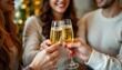 © จนา เลพล - close up of people toasting with christmas champagne glasses, one subject on the left with clear positioning and ample copy space, optimize with cheerful lemon tones for photo use.