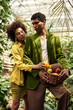 © LIGHTFIELD STUDIOS - Loving couple enjoys natures beauty while gathering fresh fruits in a vibrant greenhouse