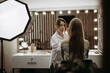 © Stanislav - Makeup artist in beauty salon works with client to create an image