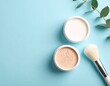 © Sherry - Pastel Beauty Flat Lay – Powder Jars and Brush on Light Blue Background